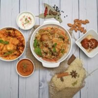 Table of Indian curries, rice and sides served at an Indian restaurant in Amsterdam