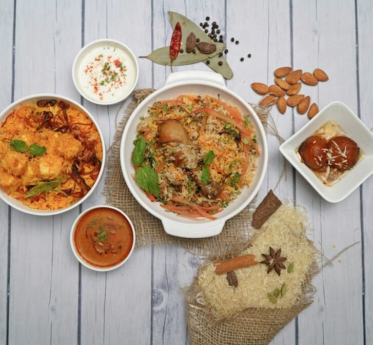 Table of Indian curries, rice and sides served at an Indian restaurant in Amsterdam