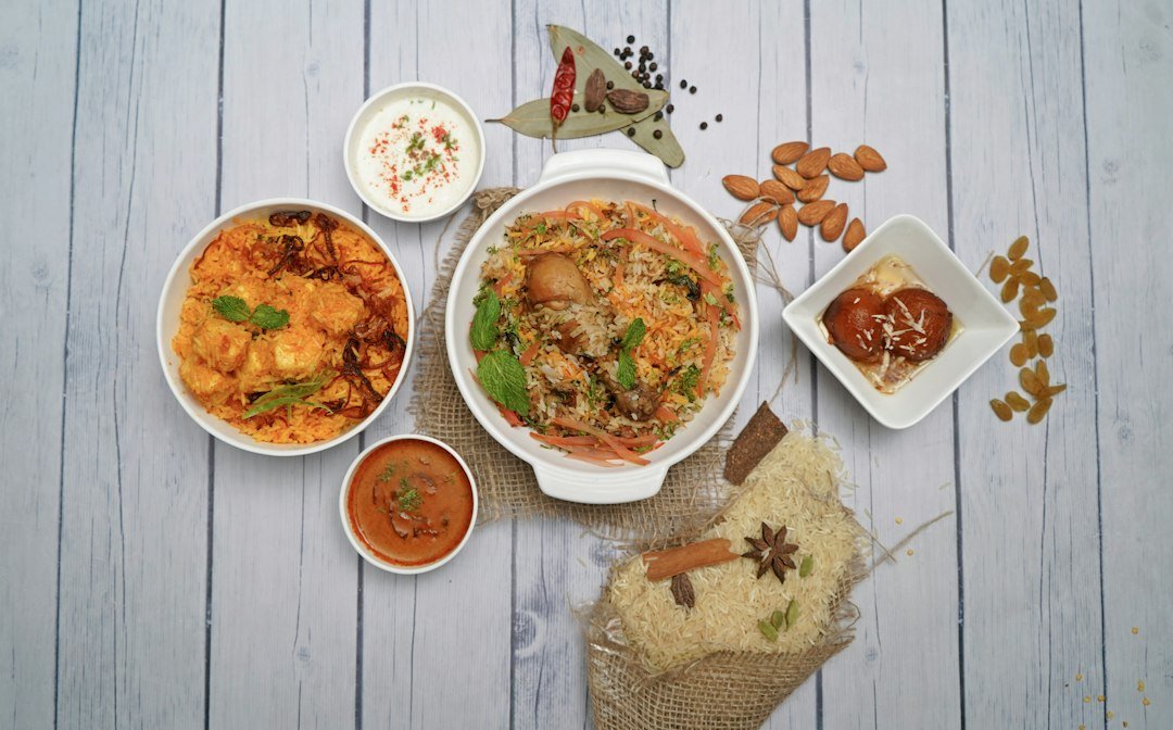 Table of Indian curries, rice and sides served at an Indian restaurant in Amsterdam
