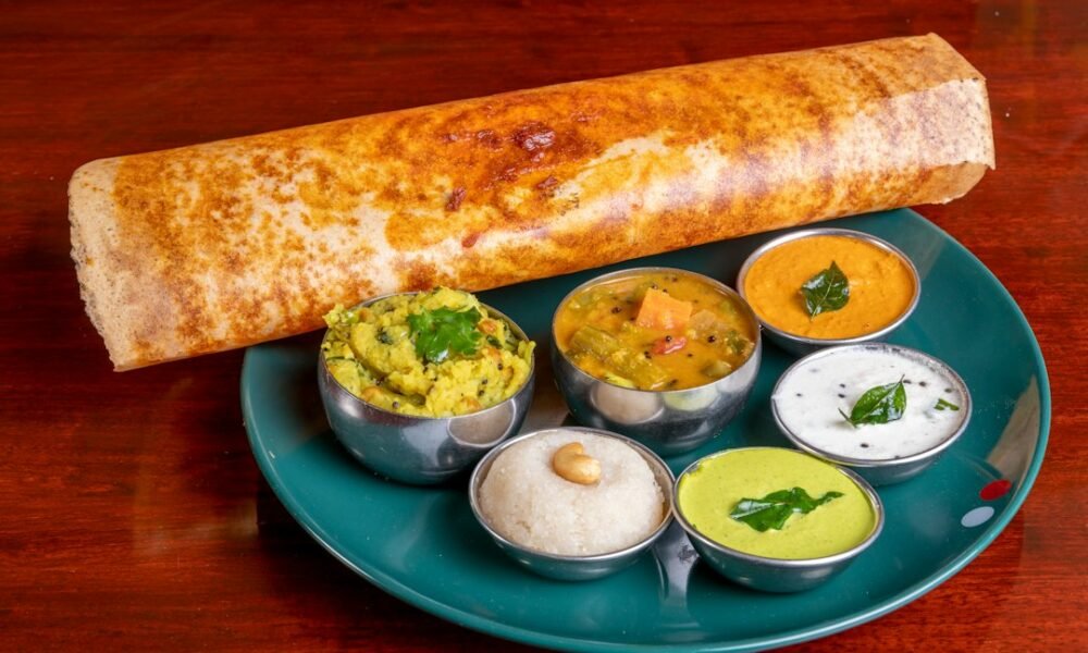 Crispy masala dosa served with coconut chutney and sambar at a South Indian restaurant in Amsterdam