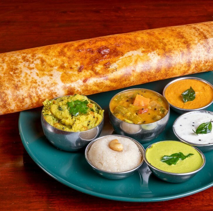 Crispy masala dosa served with coconut chutney and sambar at a South Indian restaurant in Amsterdam